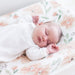 Sleeping baby lying on Parker Floral changing pad cover