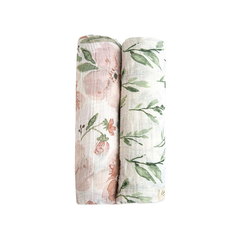 Two rolled Parker floral muslin swaddle blankets in coordinating prints