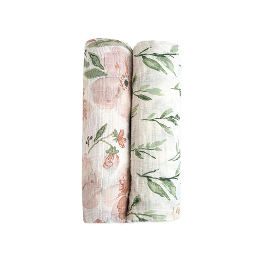 Two rolled Parker floral muslin swaddle blankets in coordinating prints
