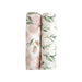 Two rolled Parker floral muslin swaddle blankets in coordinating prints