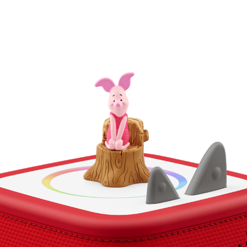 Toy figure of a pig on a red and white base with shark fins