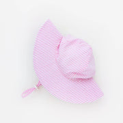 Pink striped baby hat on a light gray background