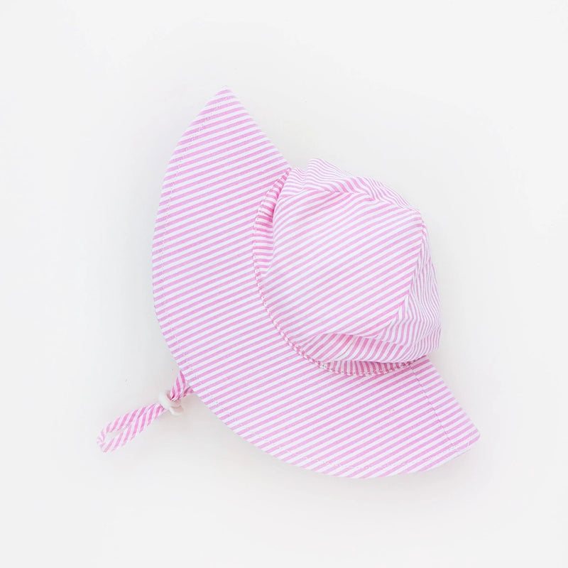 Pink striped baby hat on a light gray background