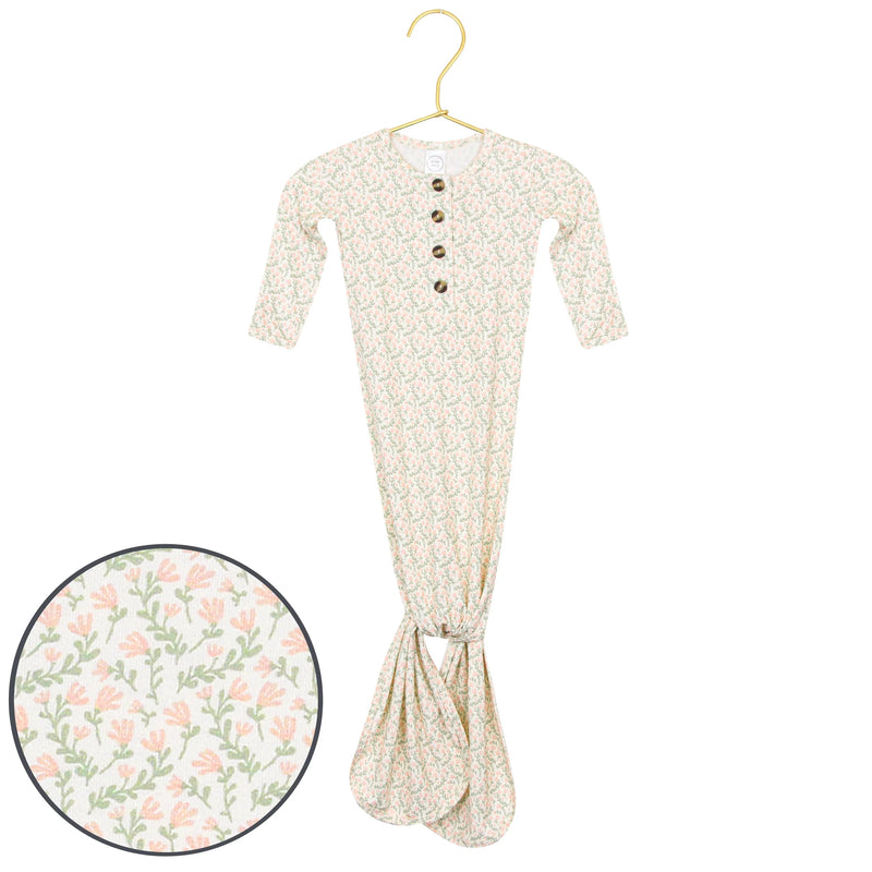 Floral-patterned baby outfit on a hanger with a close-up of the pattern.