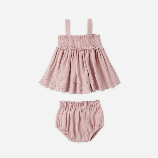 Pink baby dress with matching bloomers on a white background