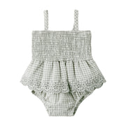 Green and white checkered baby romper with lace details on a white background