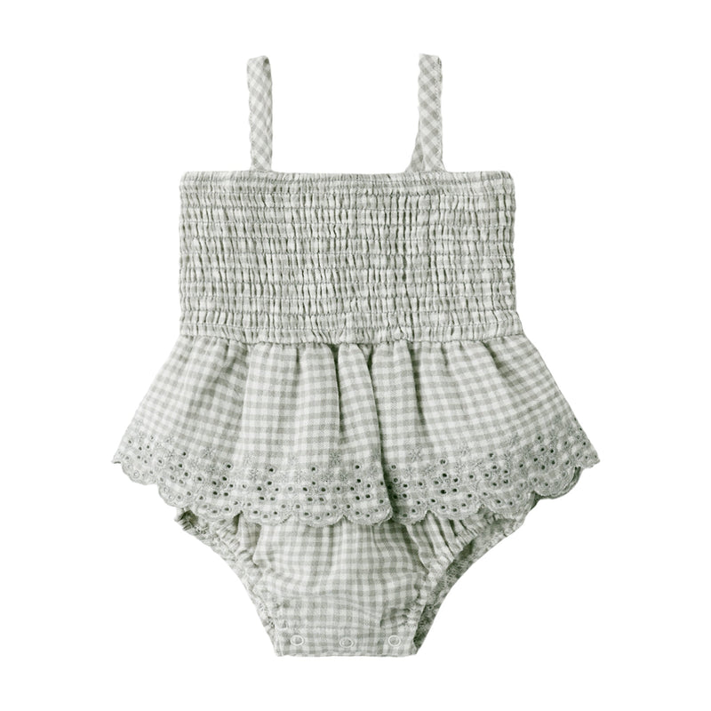Green and white checkered baby romper with lace details on a white background