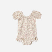 Floral-patterned baby girl swim suit on a white background