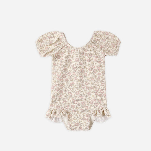 Floral-patterned baby girl swim suit on a white background