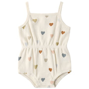 White romper with colorful heart patterns on a white background