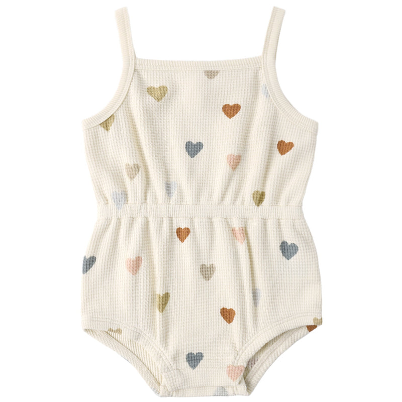 White romper with colorful heart patterns on a white background