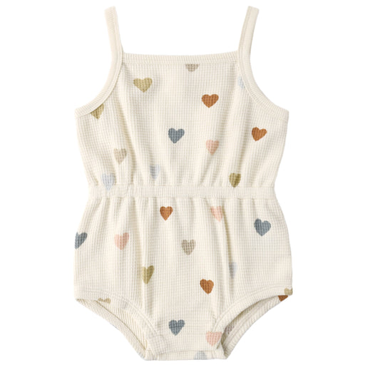 White romper with colorful heart patterns on a white background