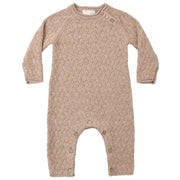 A long-sleeve baby romper in a textured cable-knit pattern, featuring a warm taupe-beige color and snap closures at the neck and crotch, displayed flat against a white background.