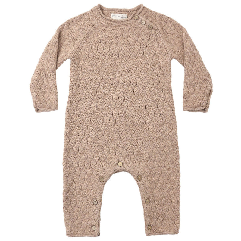 A long-sleeve baby romper in a textured cable-knit pattern, featuring a warm taupe-beige color and snap closures at the neck and crotch, displayed flat against a white background.