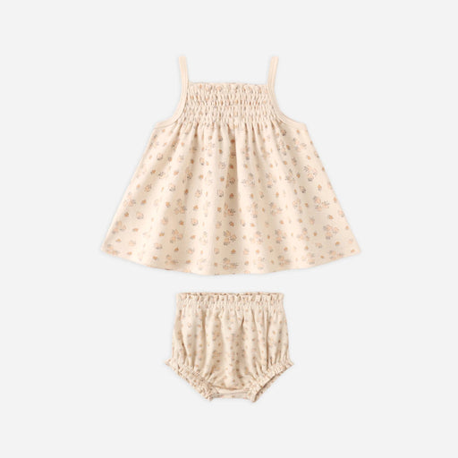 Beige patterned skirt and bloomers set on a white background