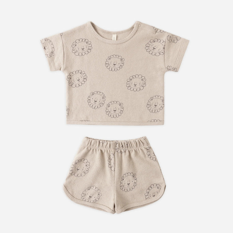 Beige children's outfit with lion patterns on a white background
