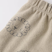 Beige fabric with lion embroidery on a white background