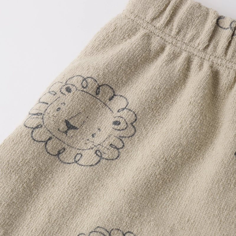 Beige fabric with lion embroidery on a white background