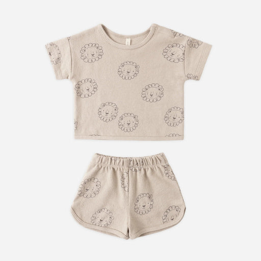 Beige children's outfit with lion patterns on a white background