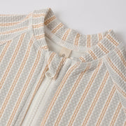 Textured fabric with a subtle pattern on a light gray background