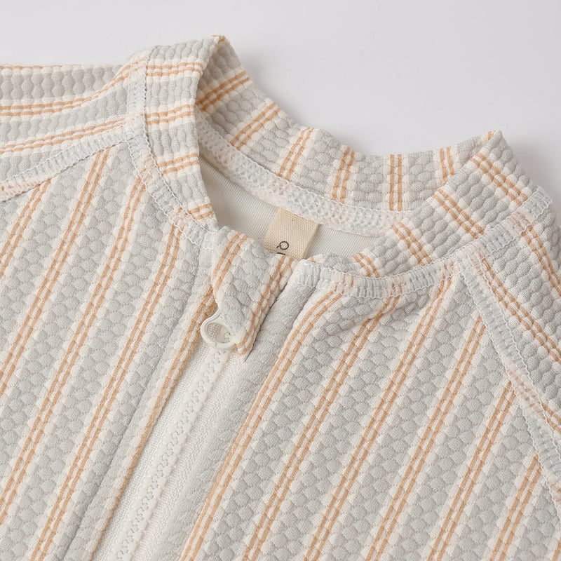 Textured fabric with a subtle pattern on a light gray background