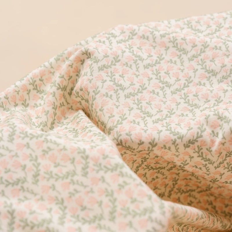 Floral patterned fabric with a soft focus on a beige background