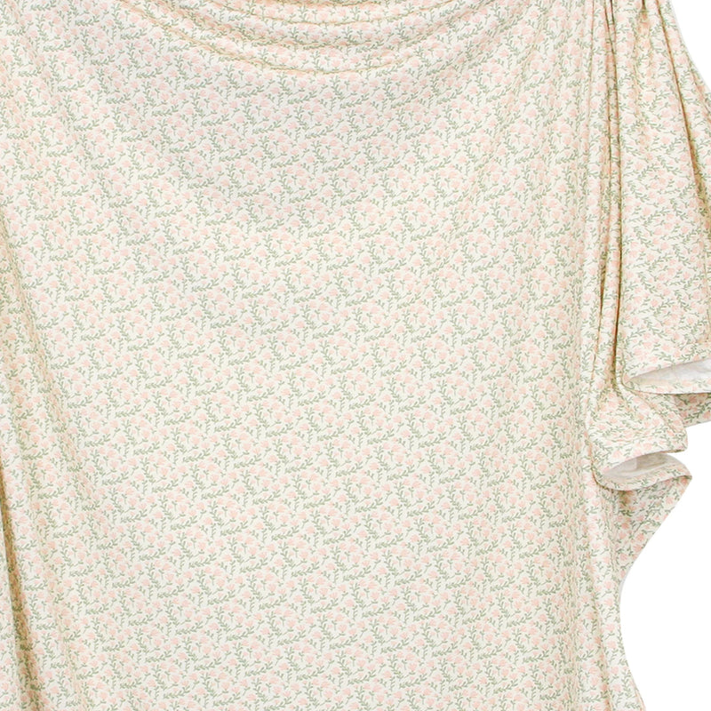 Close-up of a floral-patterned fabric with a light background