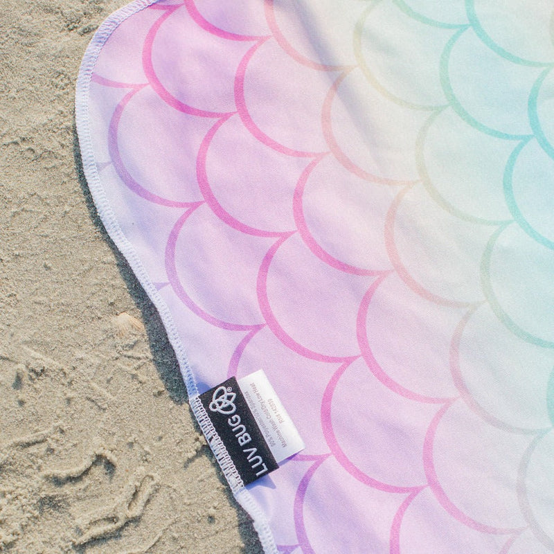 Colorful towel with circular pattern on sand