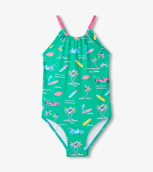 Green swimsuit with colorful beach pattern on a white background