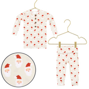 Children's pajama set with Santa Claus pattern on hangers against a white background.