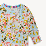 Floral-patterned baby cardigan with colorful trim on a light blue background