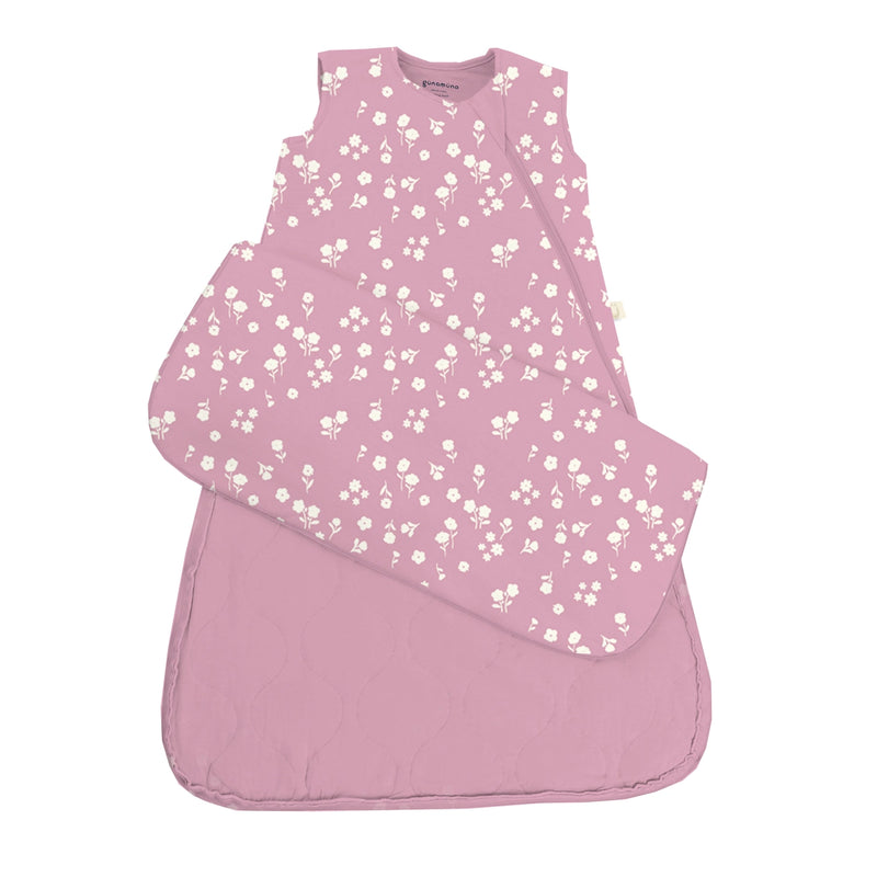 A pink Mini Floral Sleep Sack Swaddle is laid flat with one swaddle wing folded outward to show the design and shape.