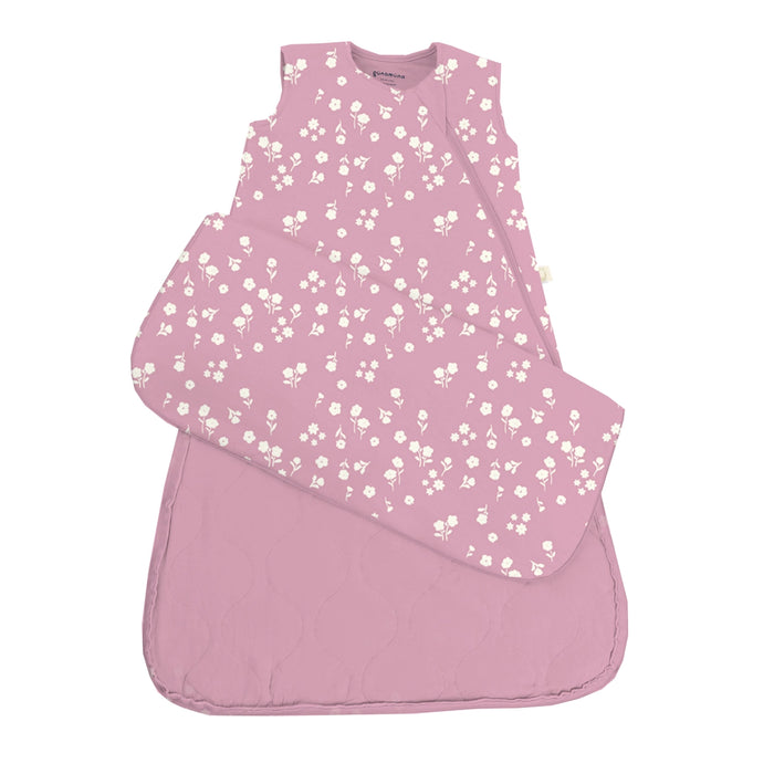A pink Mini Floral Sleep Sack Swaddle is laid flat with one swaddle wing folded outward to show the design and shape.