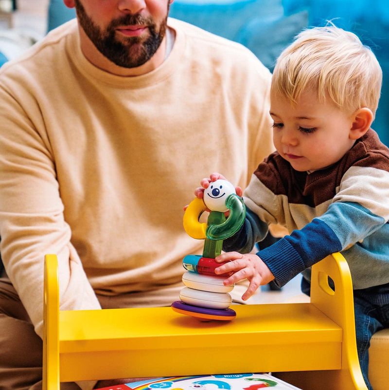 Toddler building with SmartMax My First Stacking Rings while dad watches