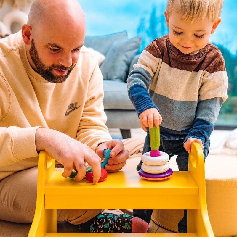 Toddler and dad playing with SmartMax My First Stacking Rings at a small table
