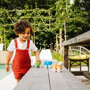 Toddler pushing SmartMax My First Vehicles trucks outdoors