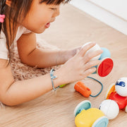 Toddler pulling SmartMax My First Wobbly Cars across the floor