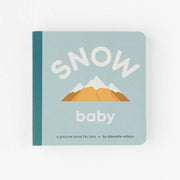 Children's book titled 'Snow Baby' with mountain illustration on a light gray background