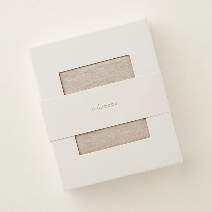 White box with 'solly baby' branding on a beige background
