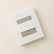 White packaging box with a clear window on a beige background