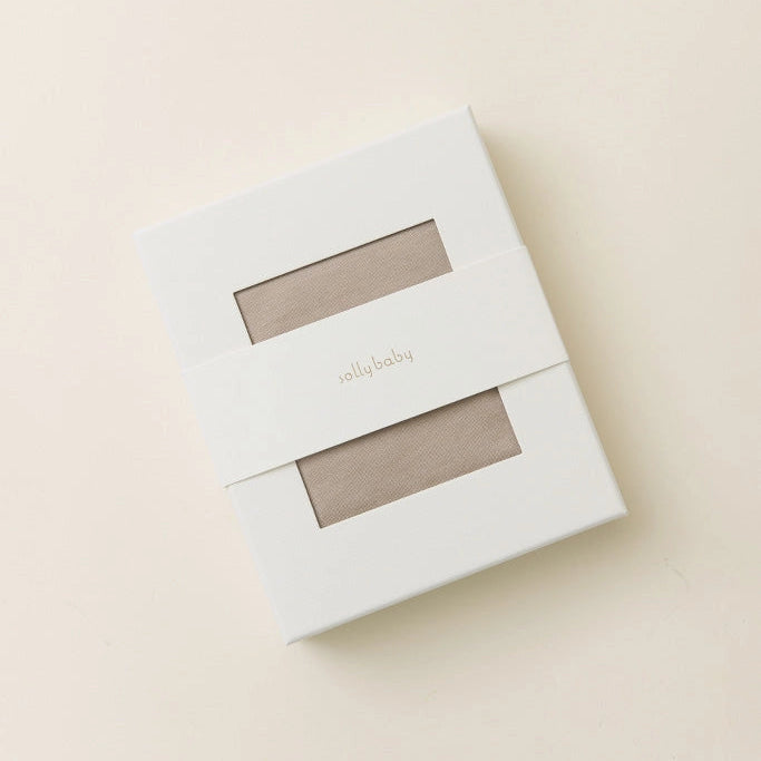 White packaging box with a clear window on a beige background