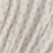 Floral patterned fabric with small flowers on a light background