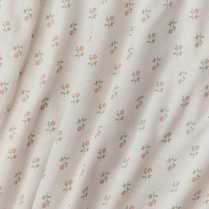 Floral patterned fabric with small flowers on a light background