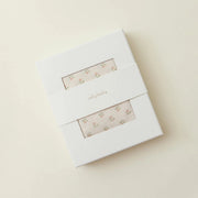 White box with floral design on a beige background