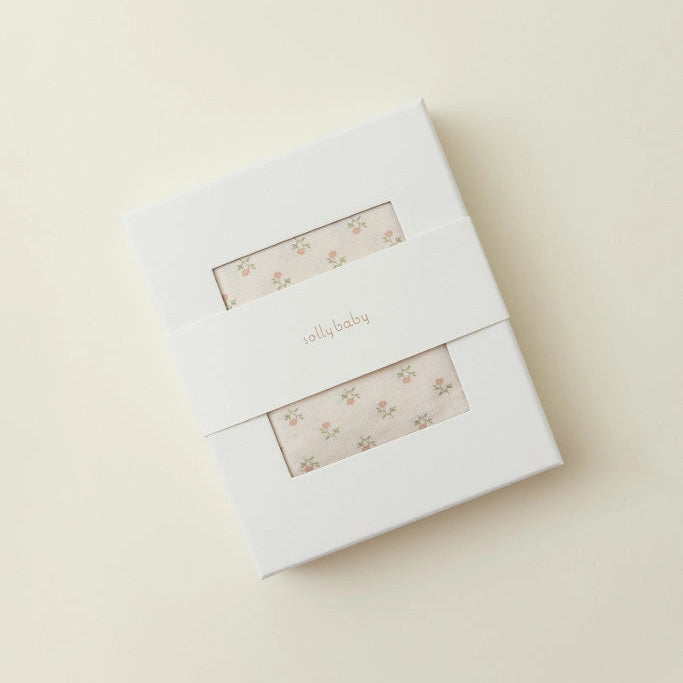 White box with floral design on a beige background