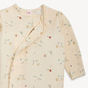 Baby outfit with long sleeves and a pattern on a white background