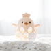 Yellow baby teether shaped like a chick on a soft white surface