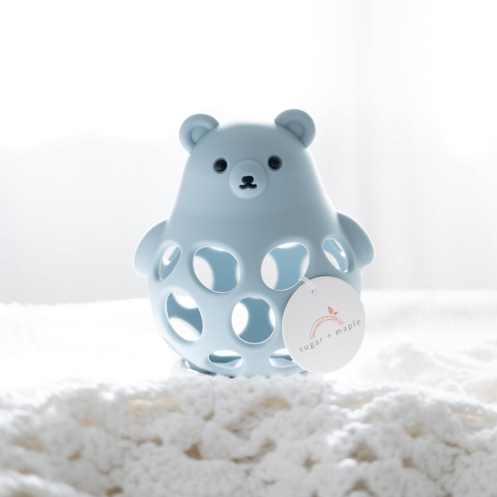 Blue bear-shaped teether on a white surface