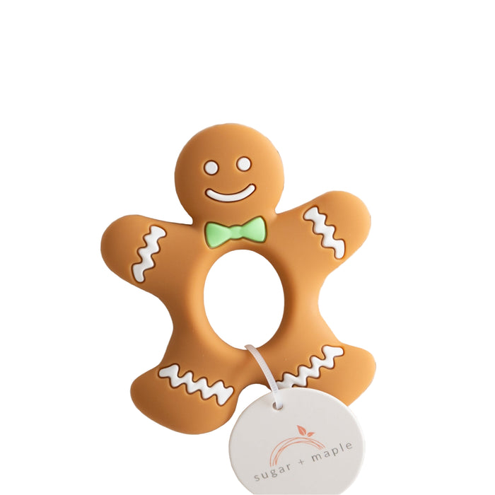 Gingerbread man teether with a tag on a textured white background