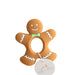 Gingerbread man teether with a tag on a textured white background